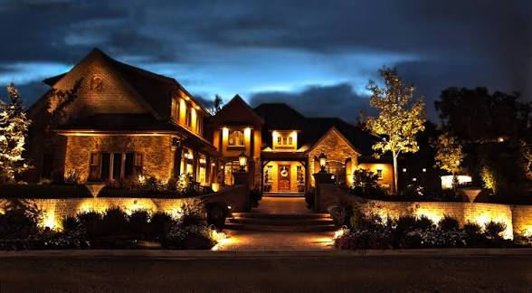 Stone driveway and pathway lighting leading to a luxury home